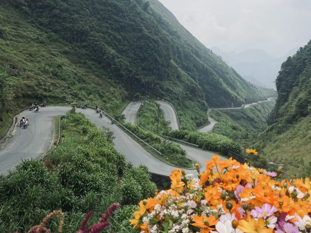 A winding road weaves between green mountains in Northern Vietnam