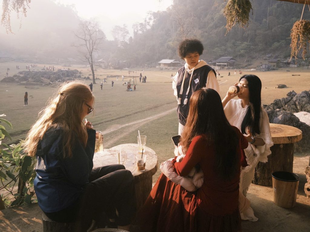Four people stand in the middle of a valley