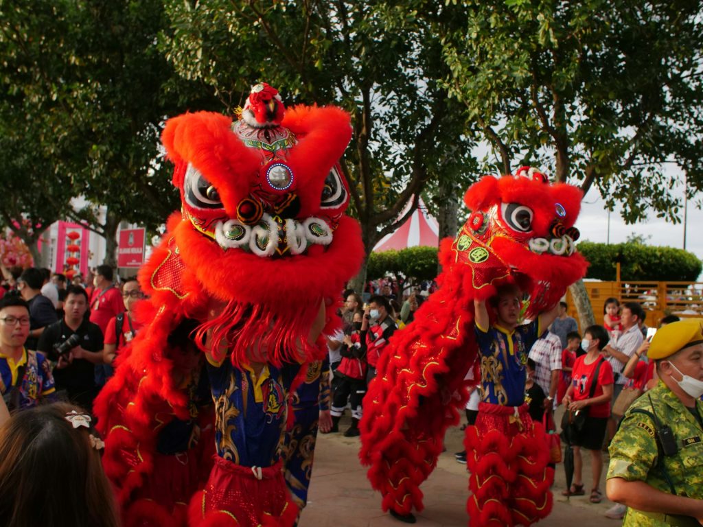 a couple of people that are standing in the street at Vietnam's Mid-Autumn festival